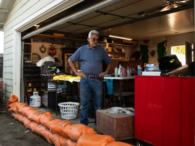 Gregory Montoya in his garage where he stores antique items that were severely damaged by recent floods in the Southcrest neighborhood of San Diego. March 8, 2024. Photo by Adriana Heldiz, CalMatters